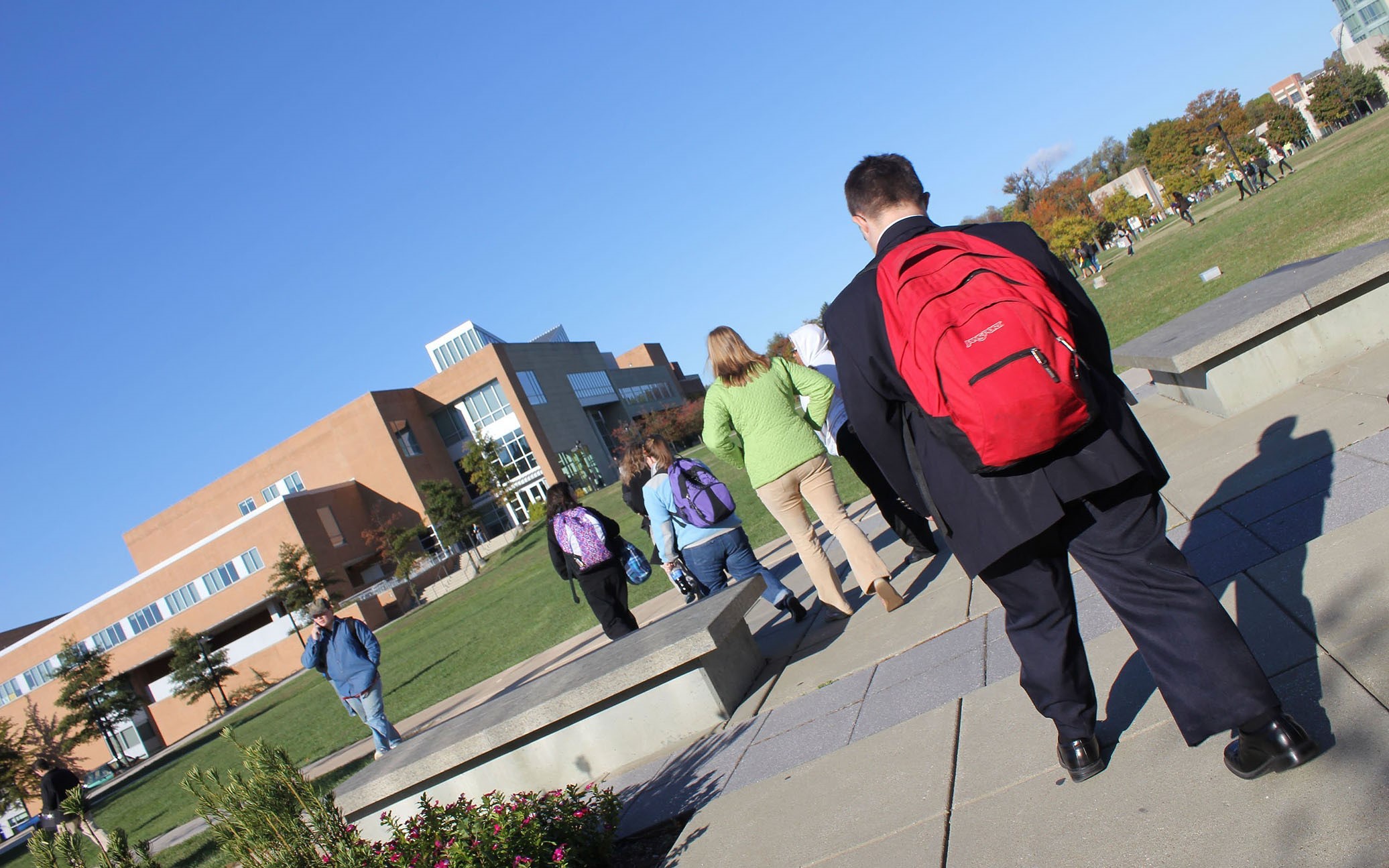 man walking to school with backpack