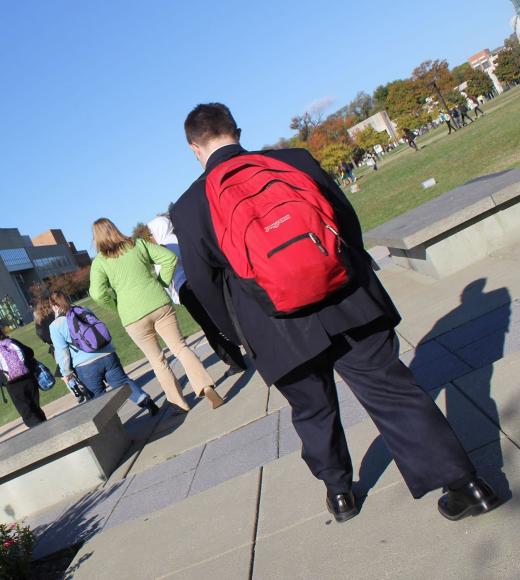 man walking to school with backpack