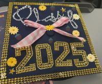 a graduation cap decorated with sparkling gold fake gems