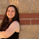 Amanda Portier leaning against a brick wall