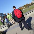 man walking to school with backpack