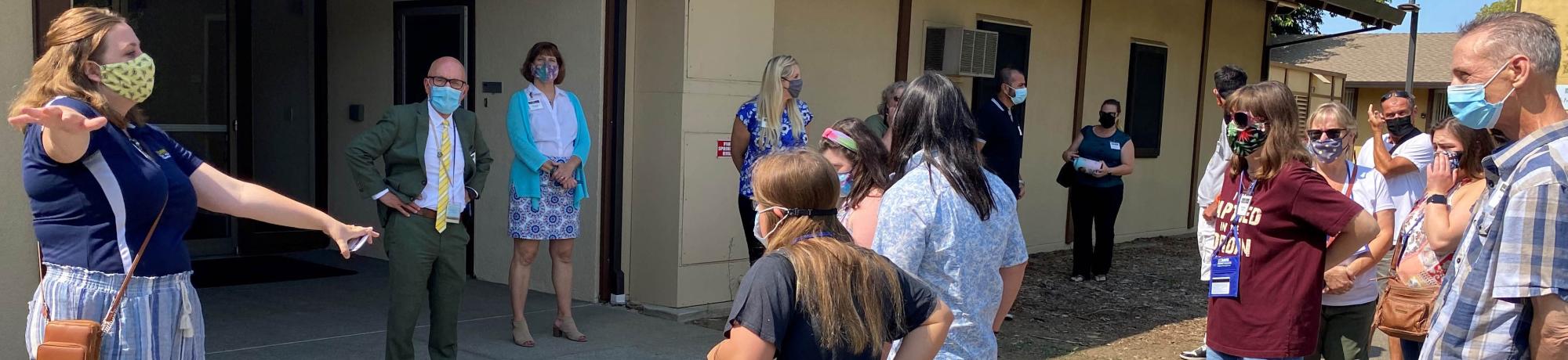 group watching person speak